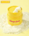 Yellow balm makeup removing container labeled 'Mango Swirl' on a yellow background