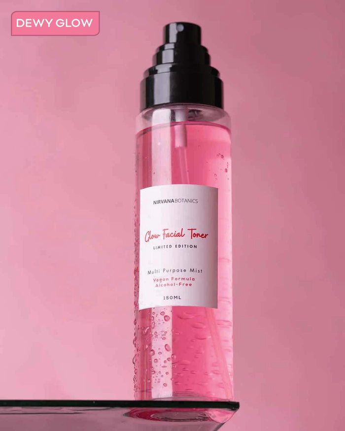 Facial toner bottle with pink liquid on a pink background