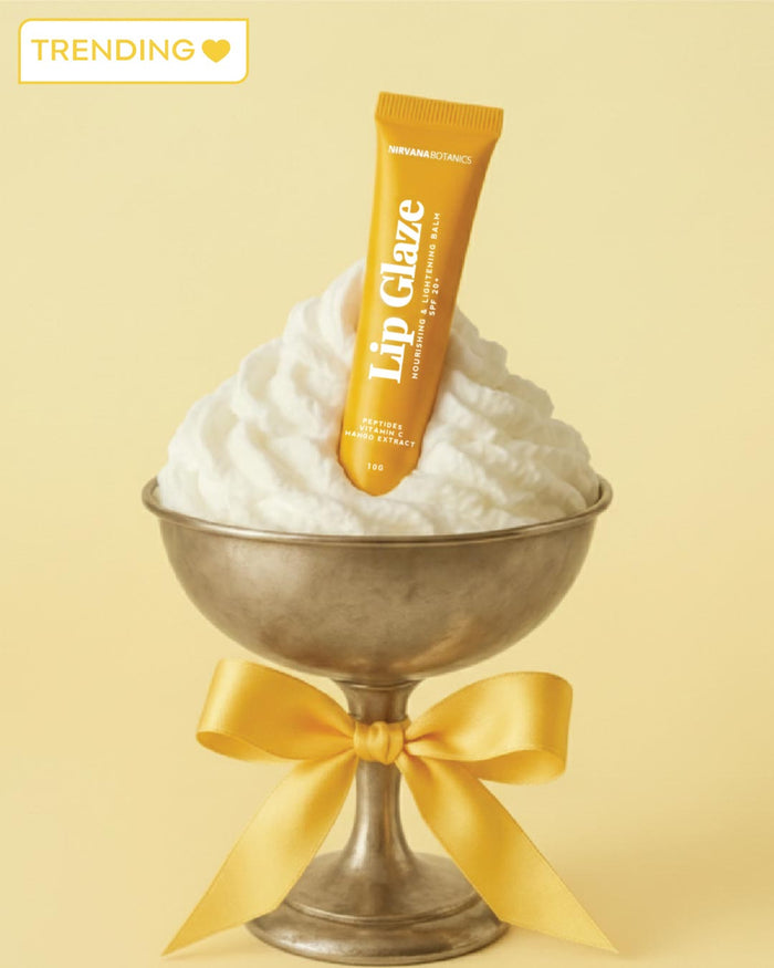 Lip glaze tube with whipped cream and a bow on a yellow background
