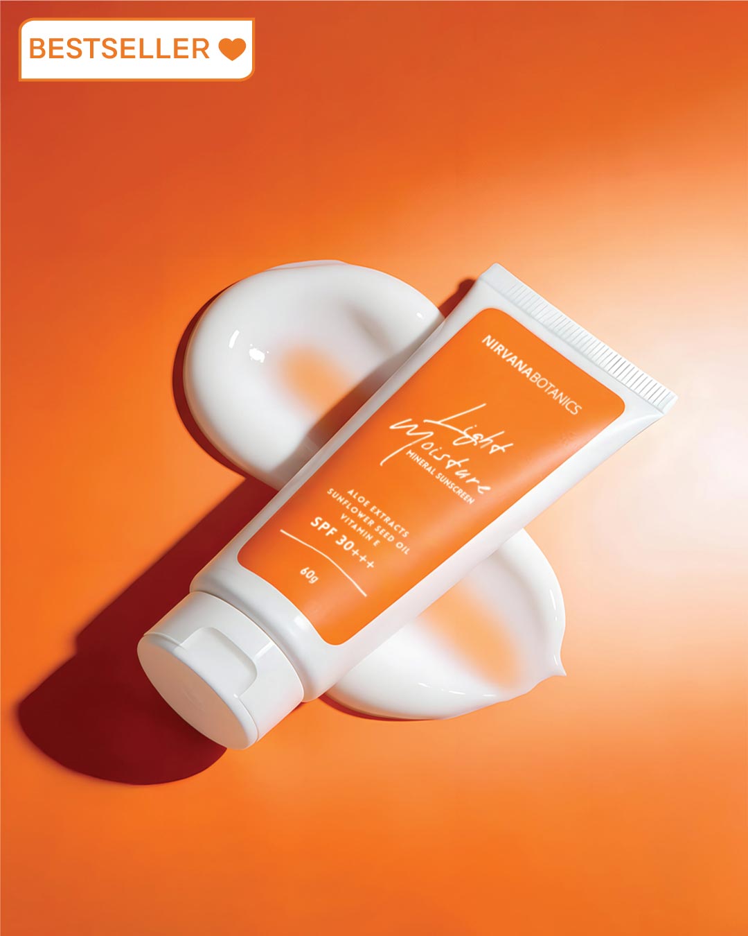 Sunscreen tube with white cap on an orange background