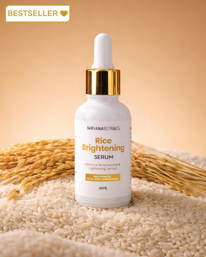 Nirvana Botanics Rice Brightening Serum bottle with rice grains and stalks on a beige background