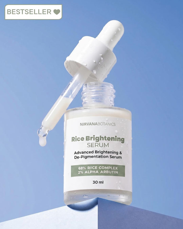 Nirvana Botanics Rice Brightening Serum in a clear glass dropper bottle with a white dropper, shown against a blue gradient background with a 'BESTSELLER' badge in the top left corner.